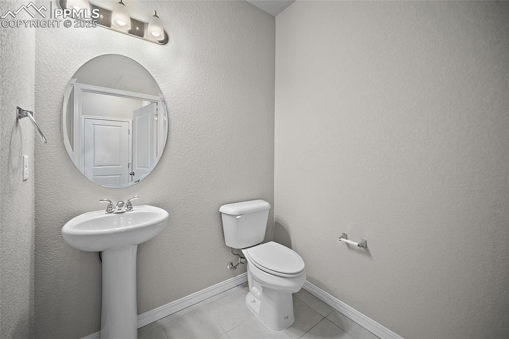 7768 Bone Crk Road Colorado Springs, CO 80924 - Photo 10 of 25 a bathroom with a toilet sink and mirror
