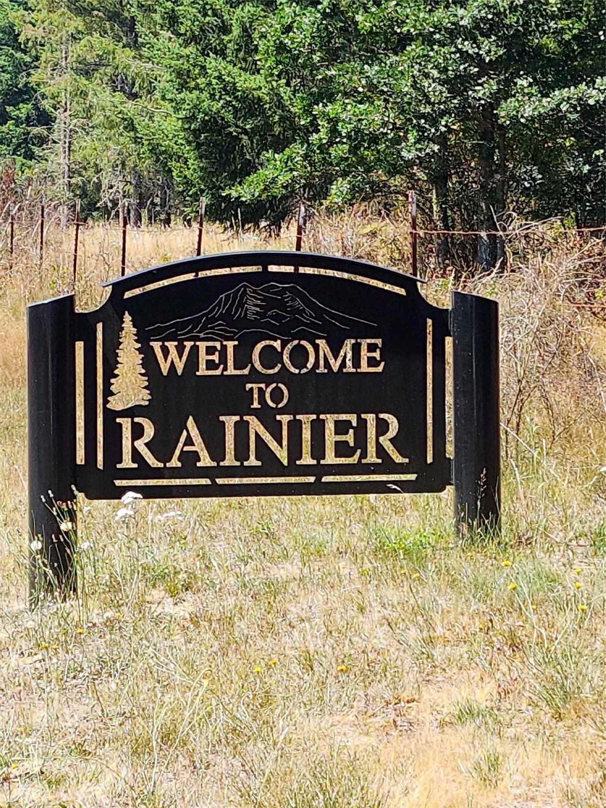 15545 Runyon Road Southeast Rainier, WA 98576 - Photo 21 of 25 a sign that is sitting on a brick wall