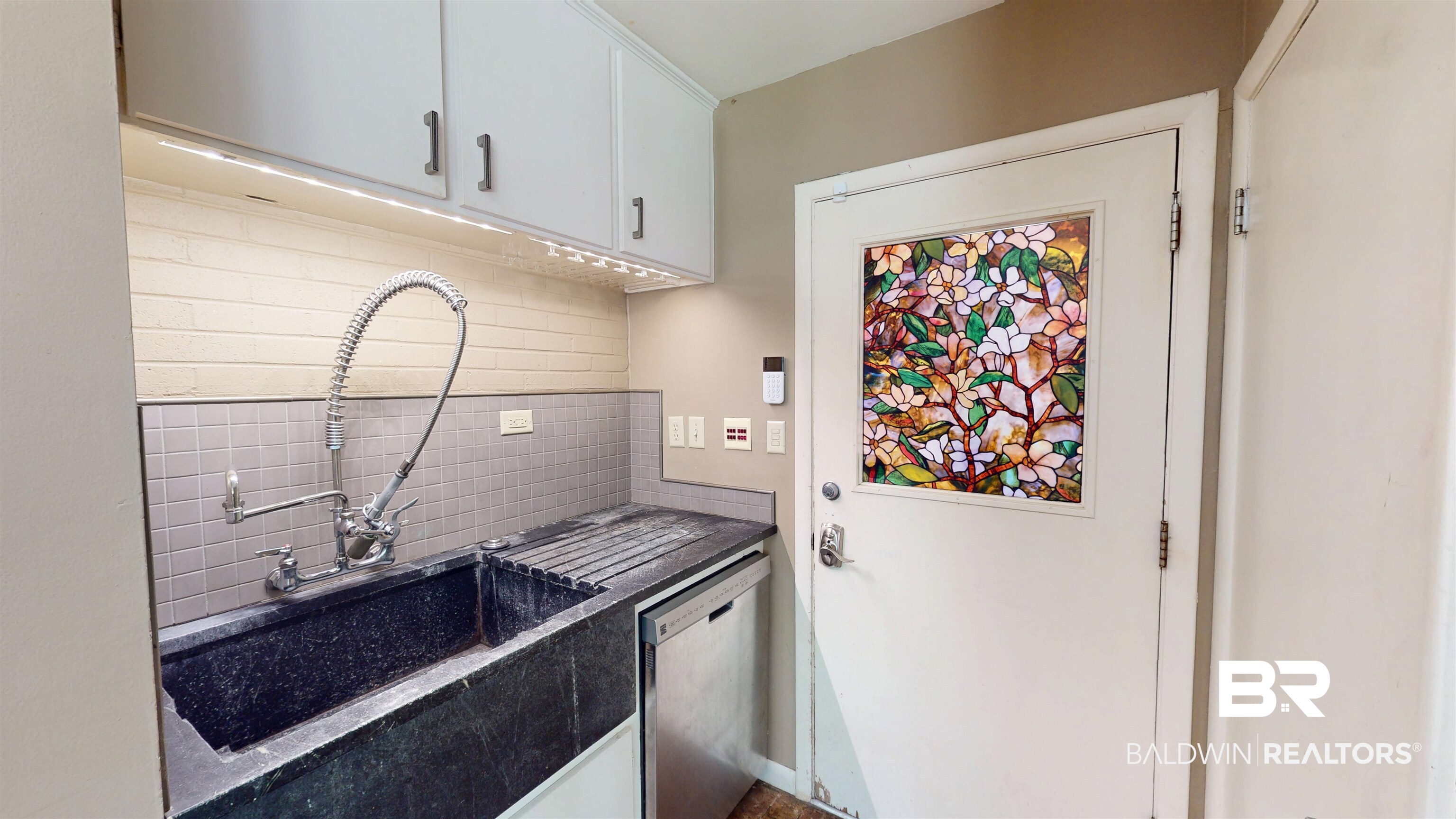 15 Spring Bank Road Mobile, AL 36608 - Photo 26 of 58 Kitchen featuring decorative backsplash and white cabinetry