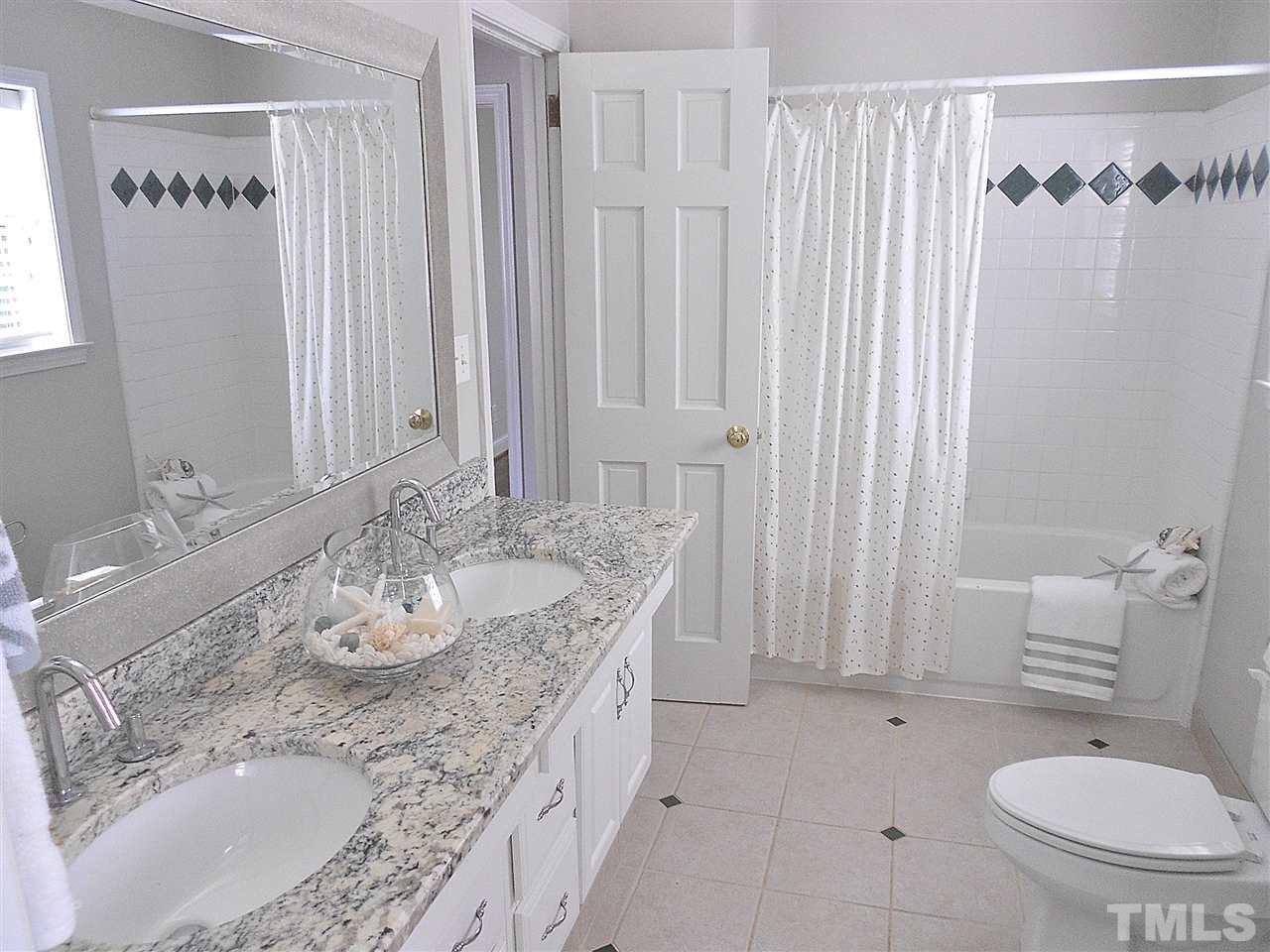3307 Hall Place Raleigh, NC 27607 - Photo 13 of 24 a bathroom with a granite countertop sink and a mirror