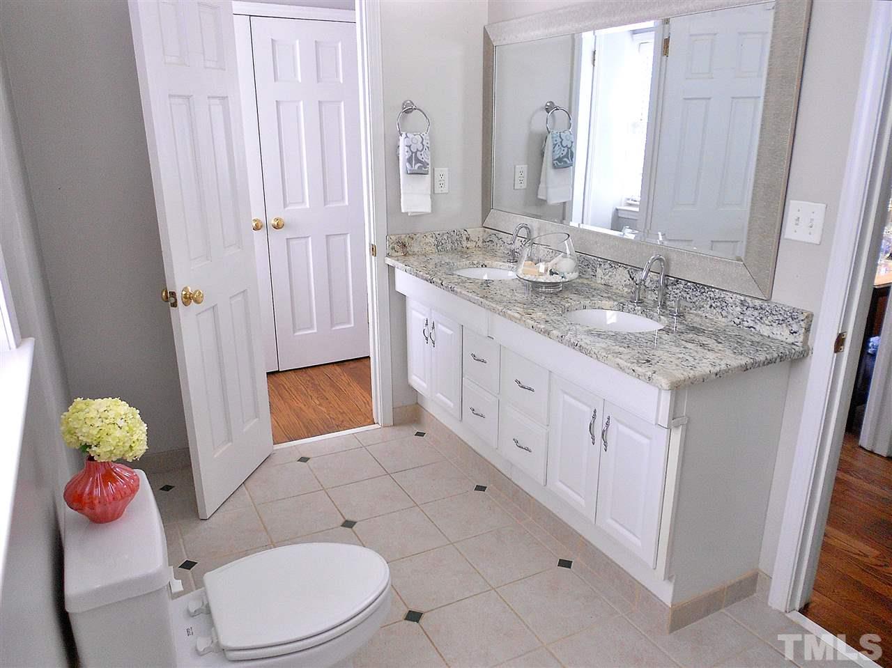 3307 Hall Place Raleigh, NC 27607 - Photo 14 of 24 a bathroom with a granite countertop sink a toilet and mirror