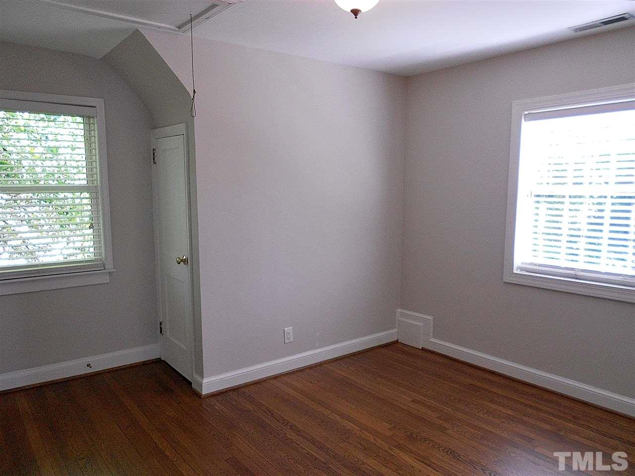 3307 Hall Place Raleigh, NC 27607 - Photo 15 of 24 an empty room with wooden floor and windows