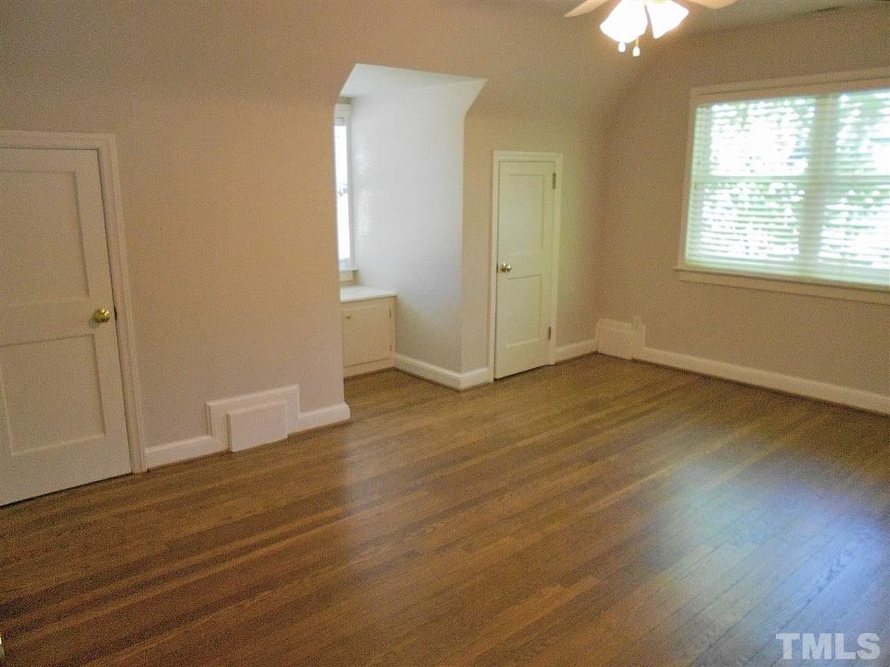 3307 Hall Place Raleigh, NC 27607 - Photo 16 of 24 an empty room with wooden floor and windows