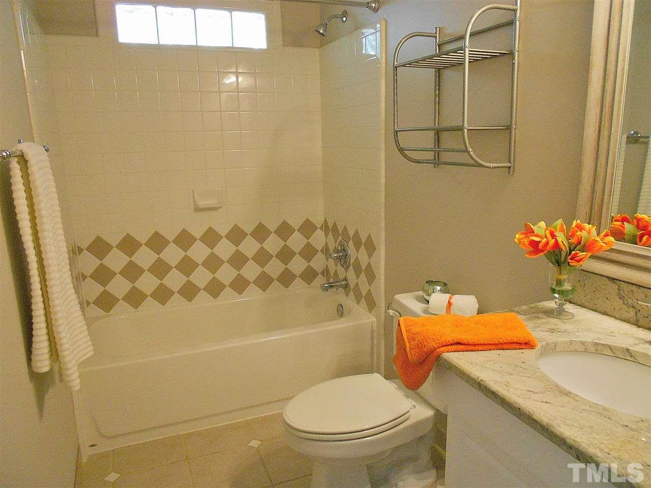 3307 Hall Place Raleigh, NC 27607 - Photo 17 of 24 a white toilet sitting next to a bathroom sink and a shower