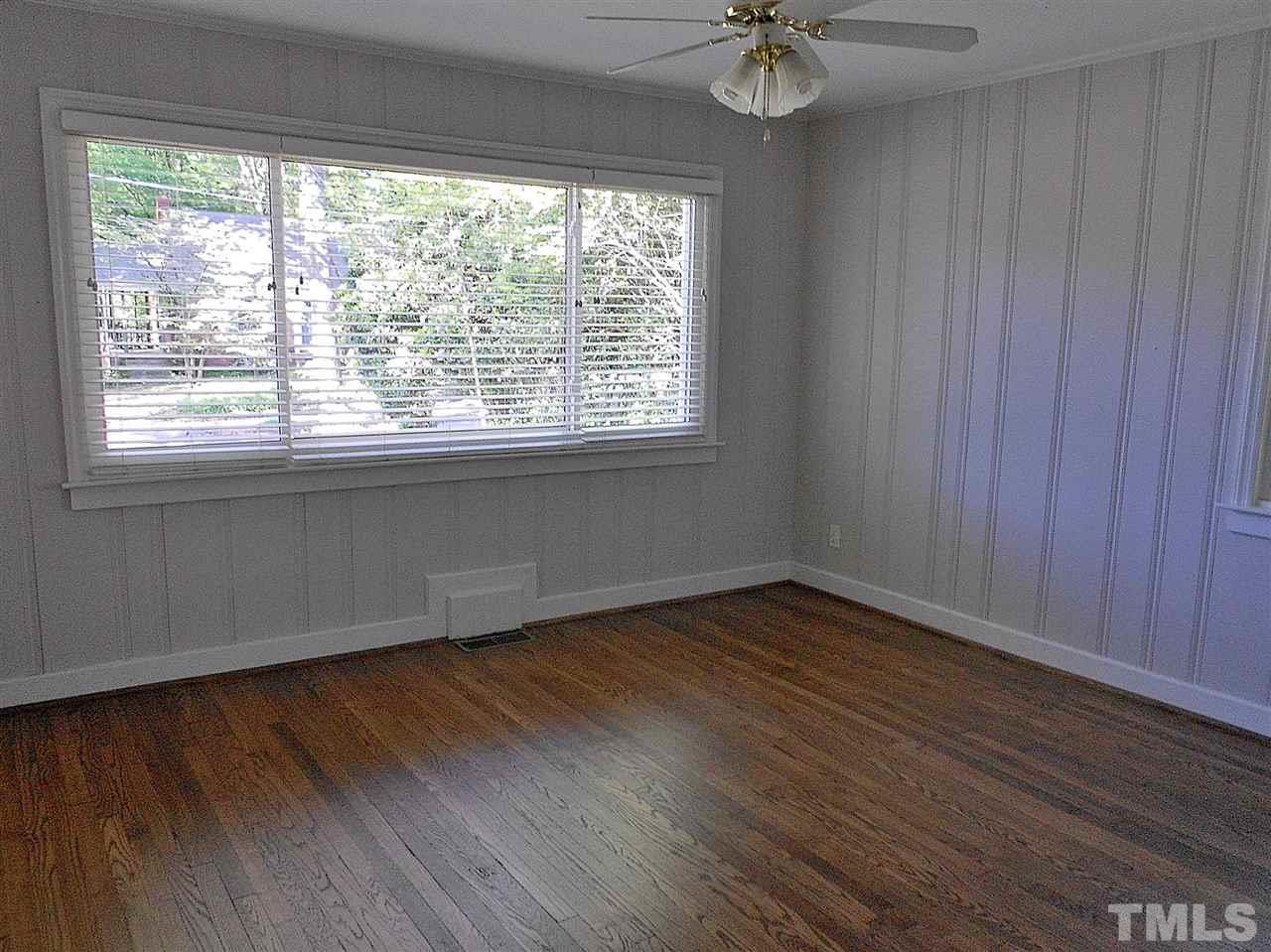 3307 Hall Place Raleigh, NC 27607 - Photo 18 of 24 a view of an empty room with a window and wooden floor