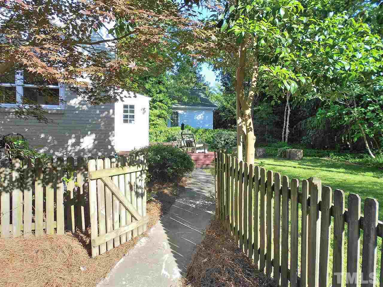 3307 Hall Place Raleigh, NC 27607 - Photo 21 of 24 a view of a house with a small yard and large trees