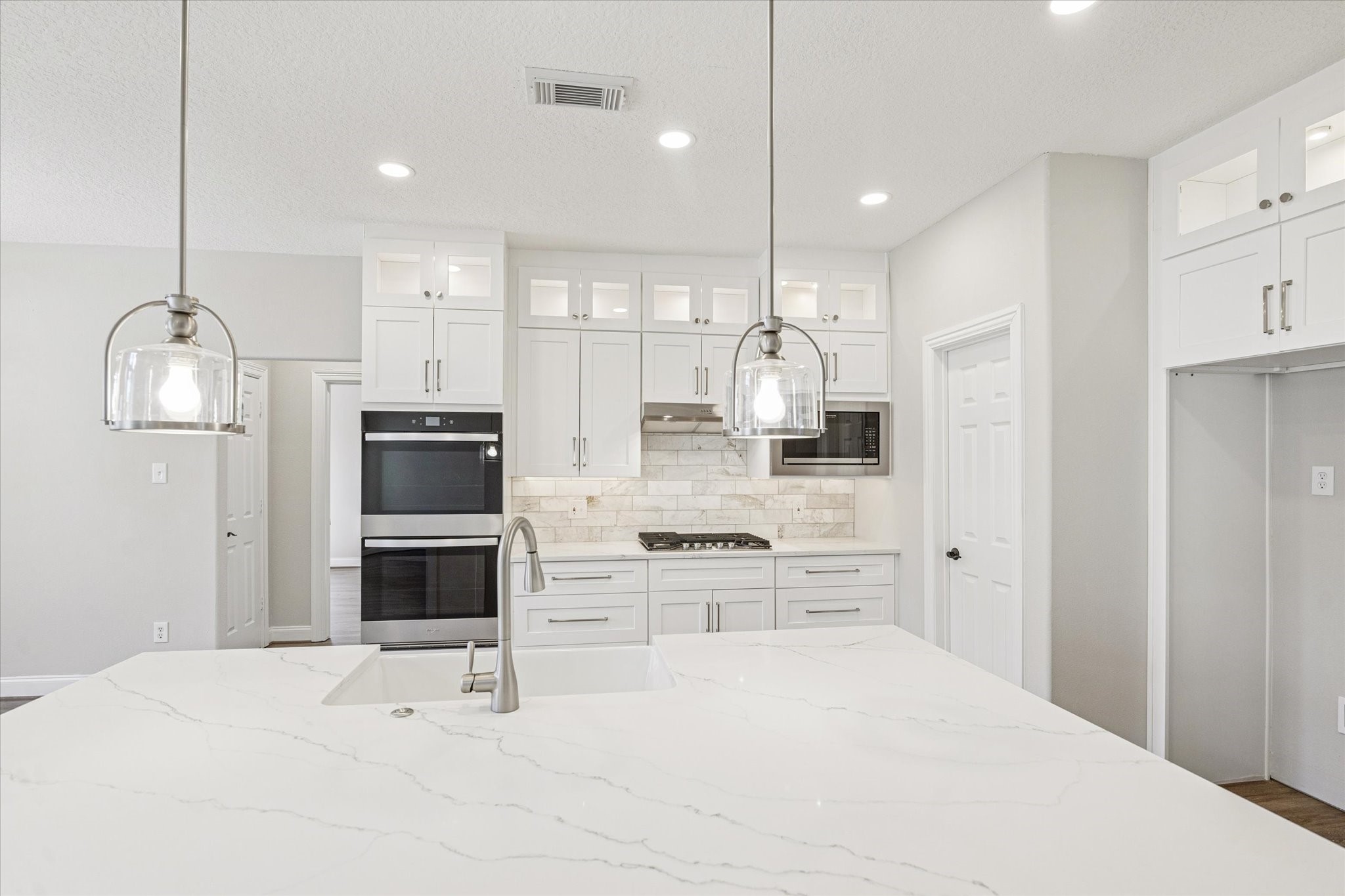 5437 Edgewater Court Willis, TX 77318 - Photo 8 of 29 a kitchen with stainless steel appliances kitchen island sink refrigerator and cabinets