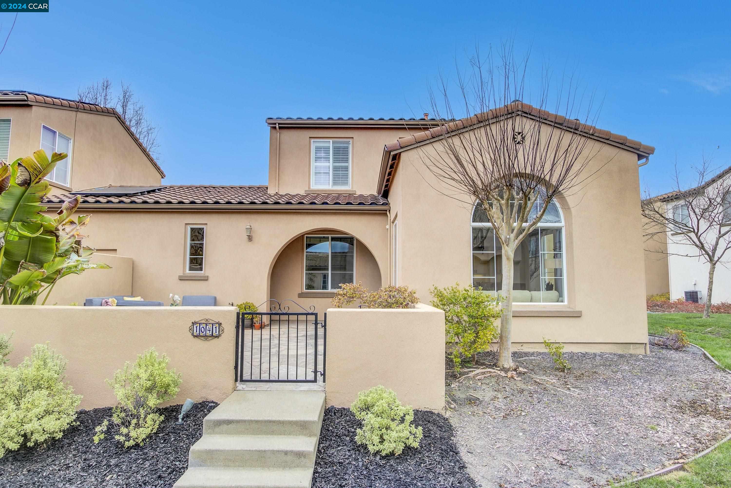 a front view of a house with a garden