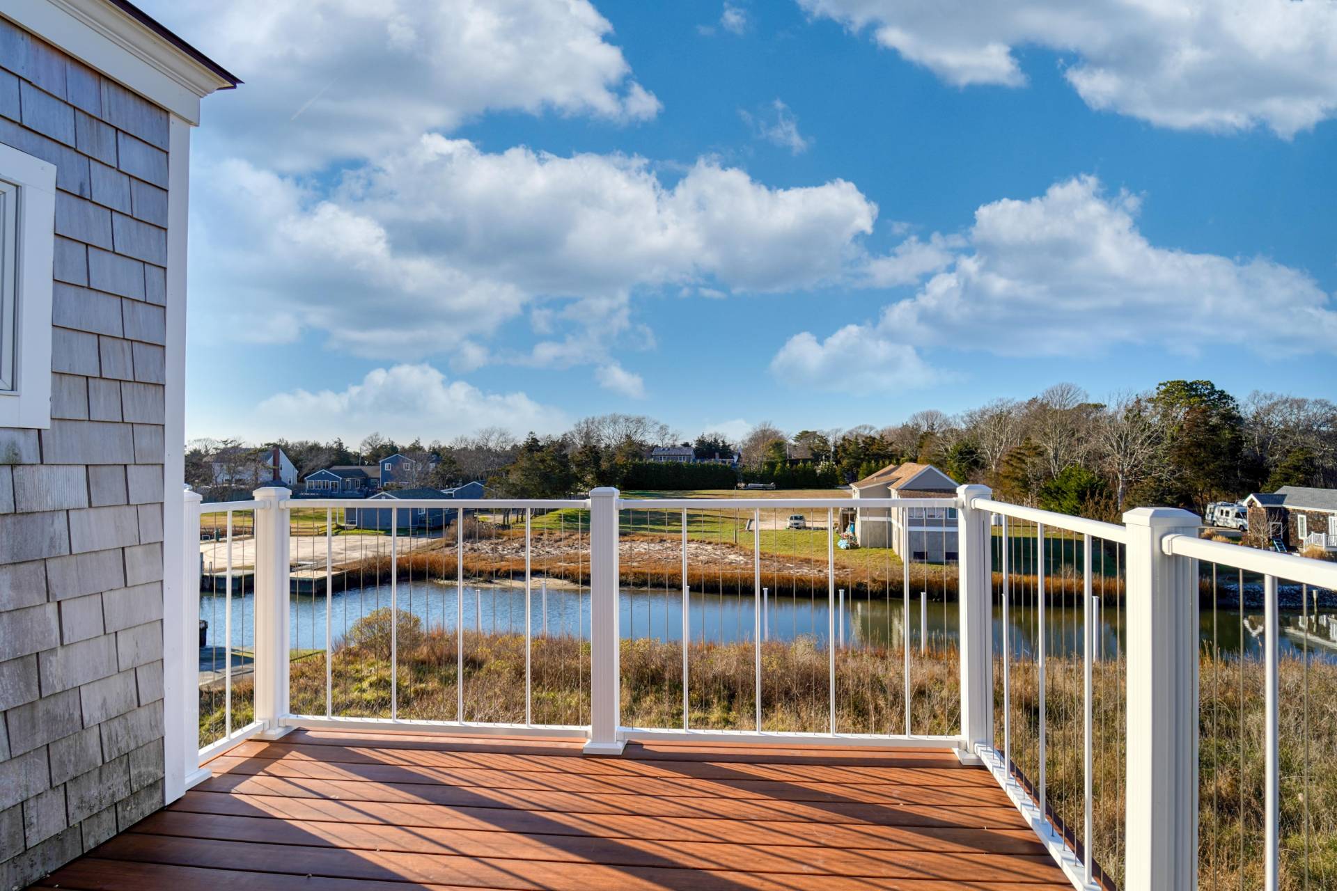 68 Foster Avenue, Unit 8 Hampton Bays, NY 11946 - Photo 1 of 20 a view of balcony with mountain view and wooden floor