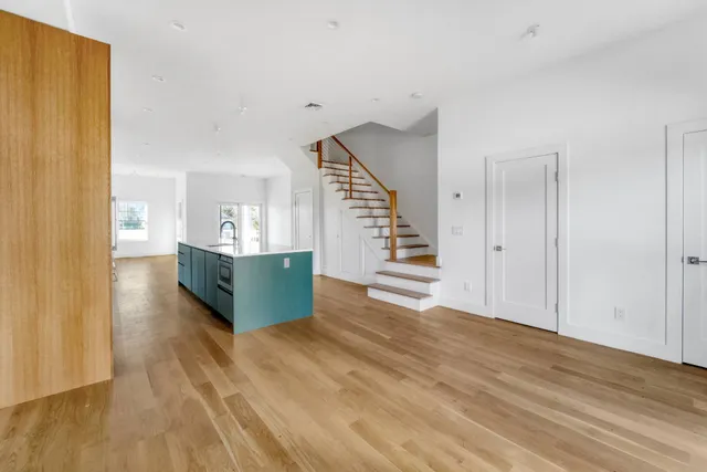 a room with wooden floors and natural light