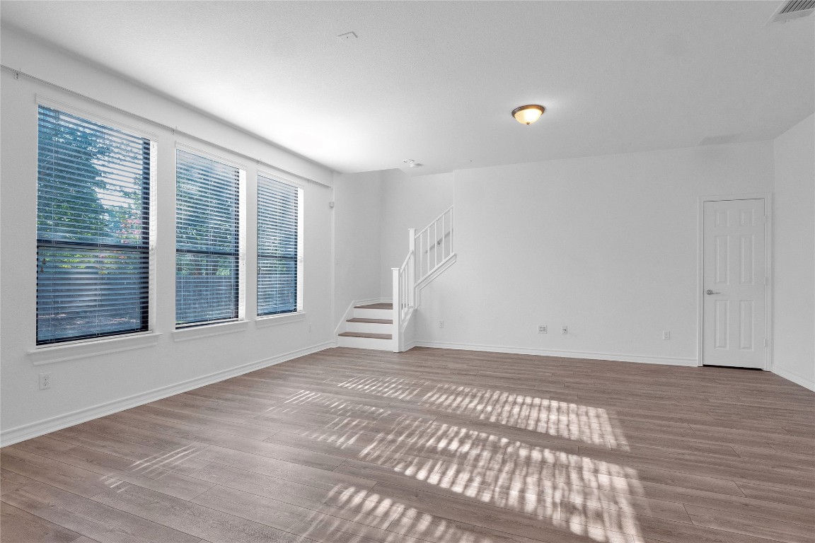 10217 English Oak Drive Austin, TX 78748 - Photo 11 of 31 a view of an empty room with wooden floor and a window