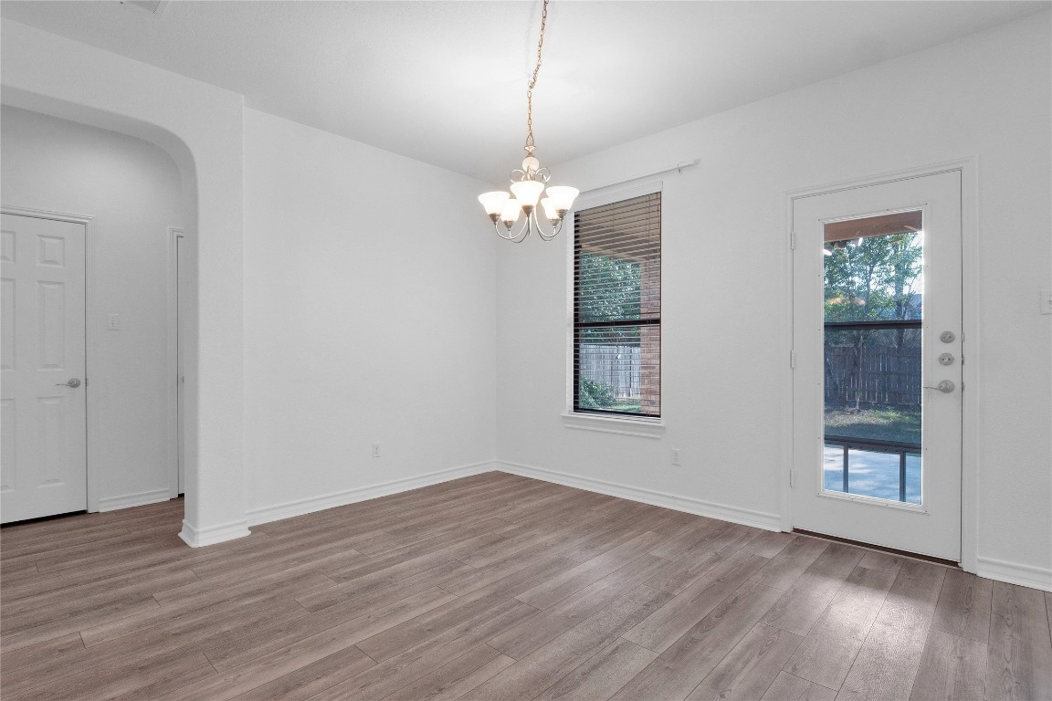 10217 English Oak Drive Austin, TX 78748 - Photo 12 of 31 a view of a room with wooden floor chandelier and windows