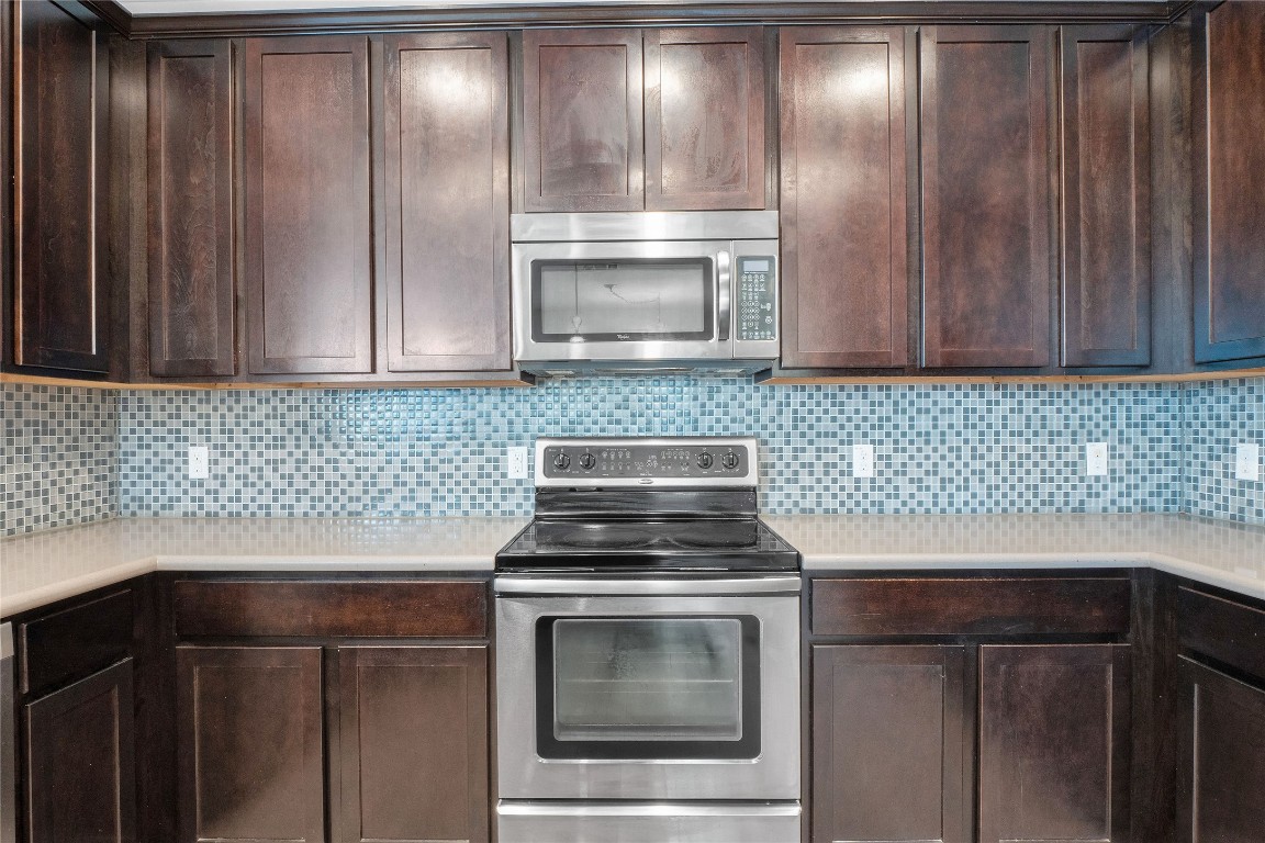 10217 English Oak Drive Austin, TX 78748 - Photo 14 of 31 a kitchen with granite countertop wood cabinets and stainless steel appliances