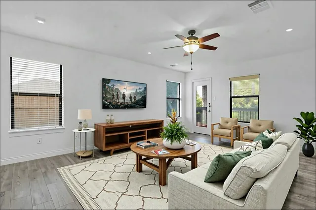 a living room with furniture a wooden floor and a window