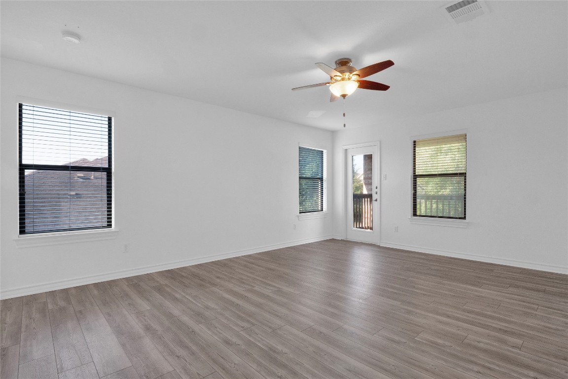 10217 English Oak Drive Austin, TX 78748 - Photo 19 of 31 a view of an empty room with wooden floor and a window