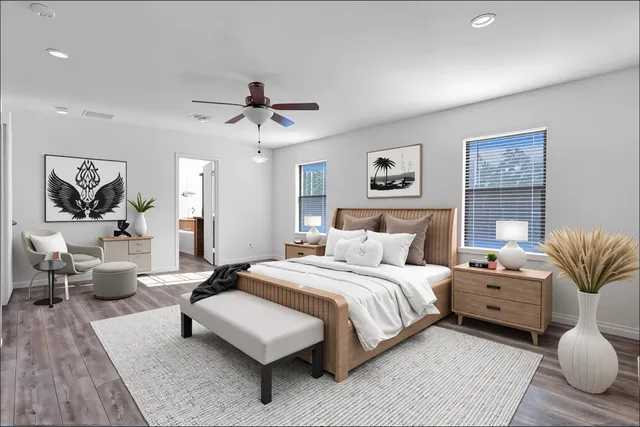 a bedroom with a bed couch and view of living room