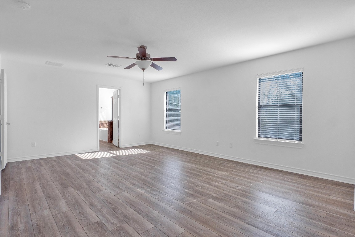 10217 English Oak Drive Austin, TX 78748 - Photo 22 of 31 a view of an empty room with a window and wooden floor