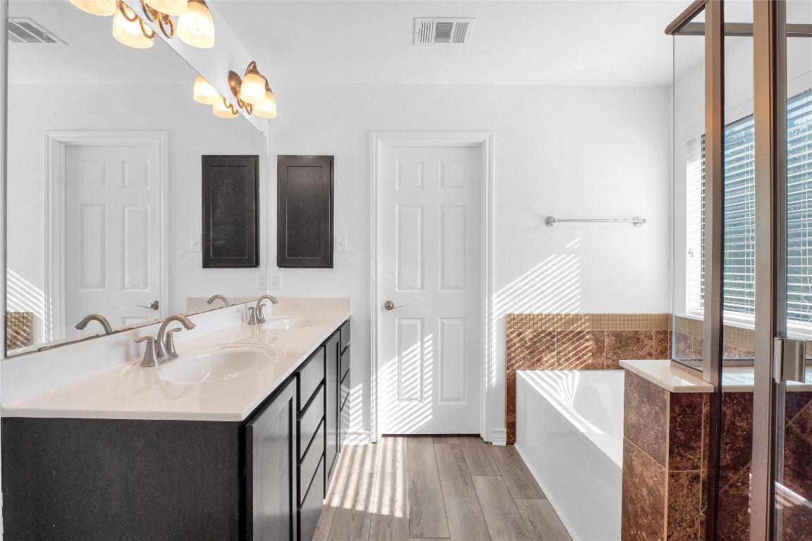 10217 English Oak Drive Austin, TX 78748 - Photo 23 of 31 a en suite bathroom with a double vanity sink and a mirror