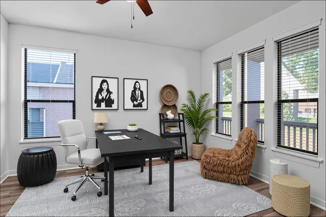 a work room with furniture and a large window