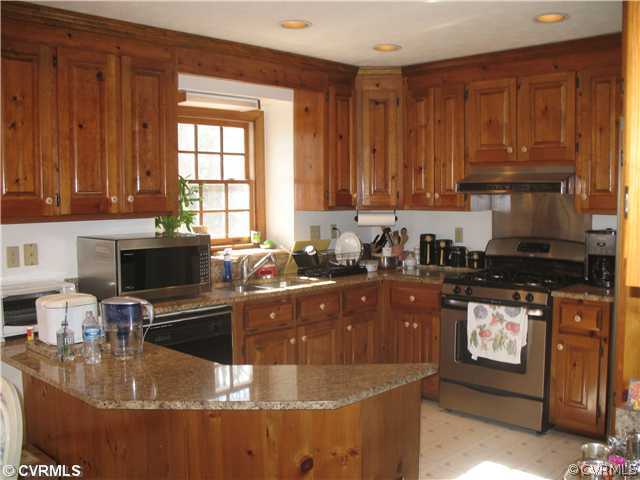 4724 Crossgate Road Chester, VA 23831 - Photo 3 of 20 a kitchen with a stove a sink and a microwave