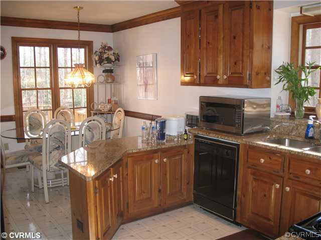4724 Crossgate Road Chester, VA 23831 - Photo 4 of 20 a kitchen with granite countertop a sink dishwasher stove and cabinets