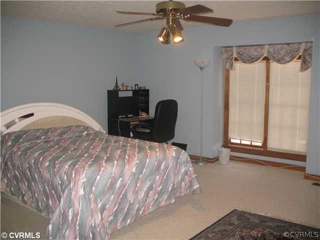4724 Crossgate Road Chester, VA 23831 - Photo 8 of 20 a bedroom with a bed dresser and a window