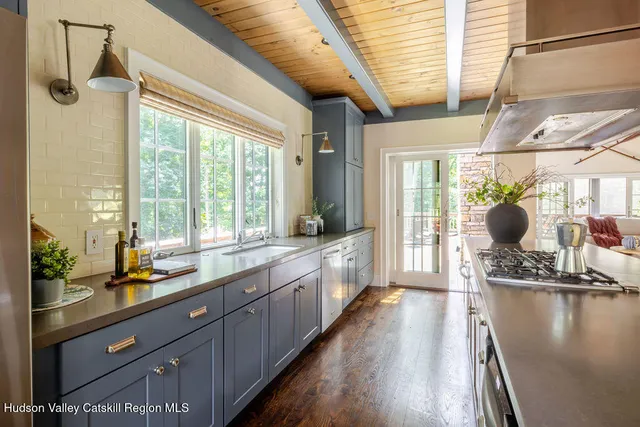 a bedroom with a bed wooden floor and window
