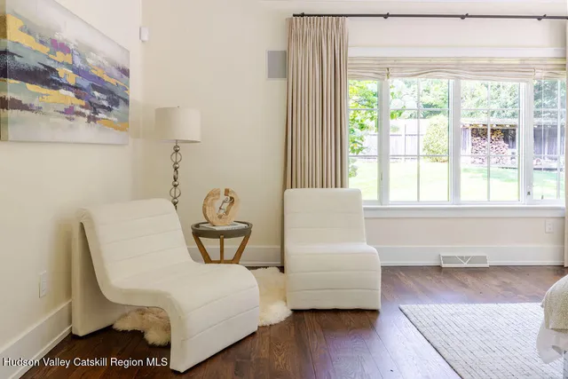 a spacious bathroom with a granite countertop sink a mirror and a shower