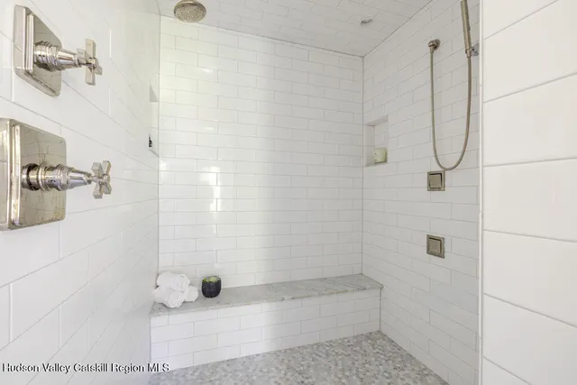 a living room with furniture and floor to ceiling windows