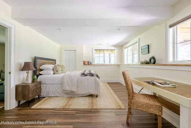 a view of a house with yard and basketball court