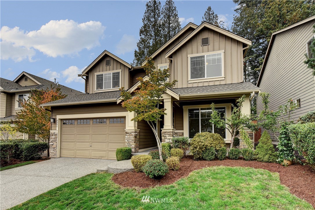 4321 229th Place Southeast Bothell, WA 98021 - Photo 1 of 31 a front view of a house with a yard and garage