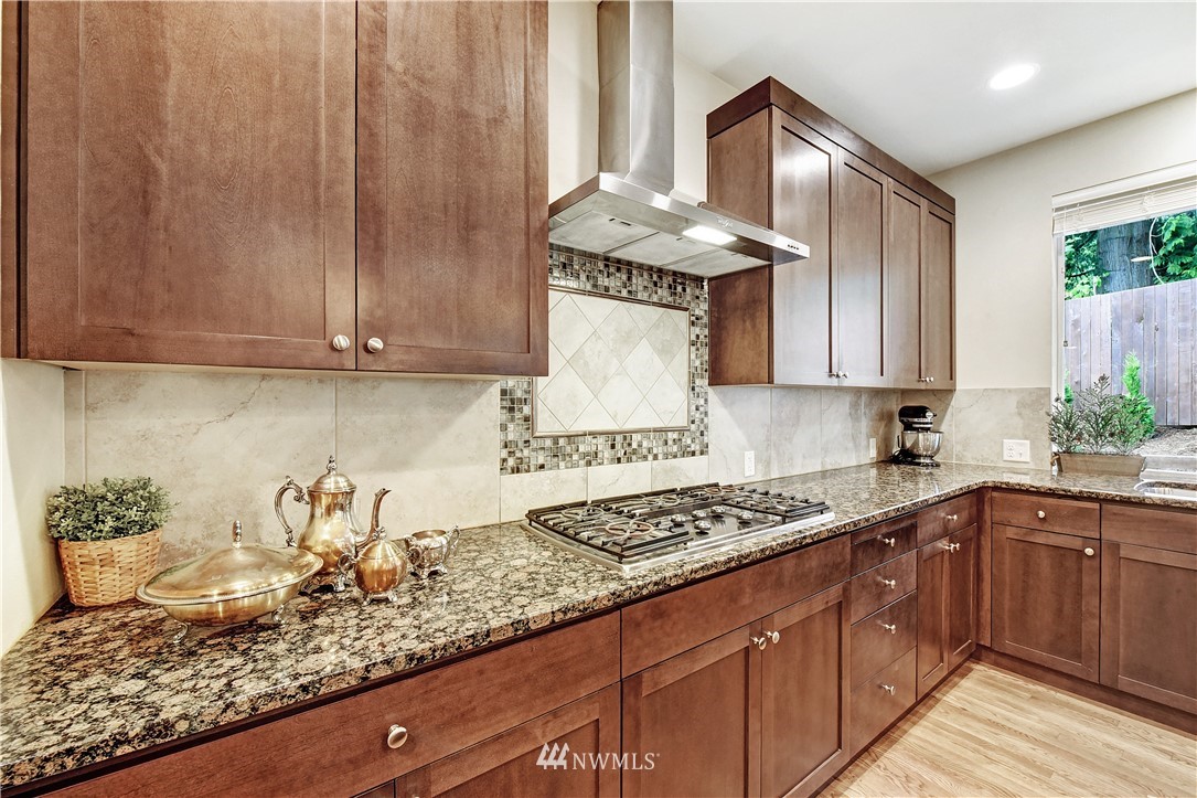 4321 229th Place Southeast Bothell, WA 98021 - Photo 11 of 31 a kitchen with granite countertop a sink a stove and cabinets