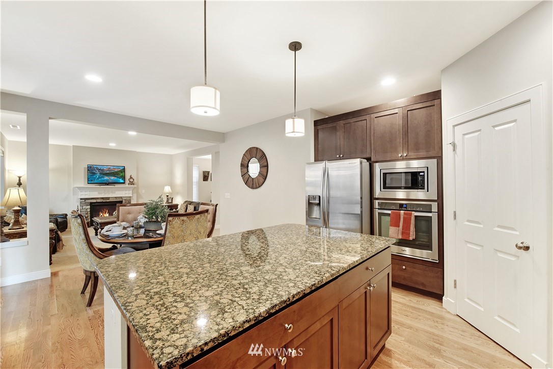 4321 229th Place Southeast Bothell, WA 98021 - Photo 12 of 31 a kitchen with stainless steel appliances granite countertop a sink refrigerator and cabinets