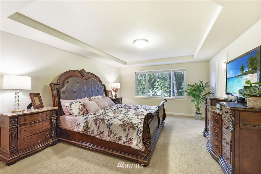 4321 229th Place Southeast Bothell, WA 98021 - Photo 14 of 31 a bedroom with a bed and a dresser next to a window