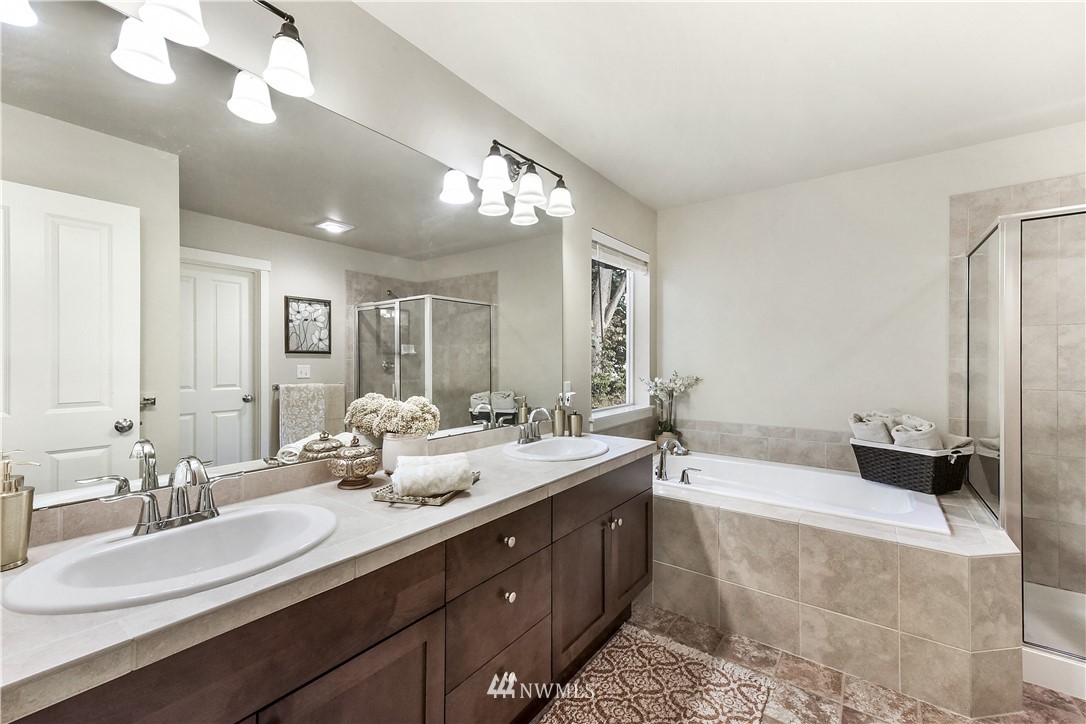 4321 229th Place Southeast Bothell, WA 98021 - Photo 16 of 31 a spacious bathroom with a double vanity sink and a mirror