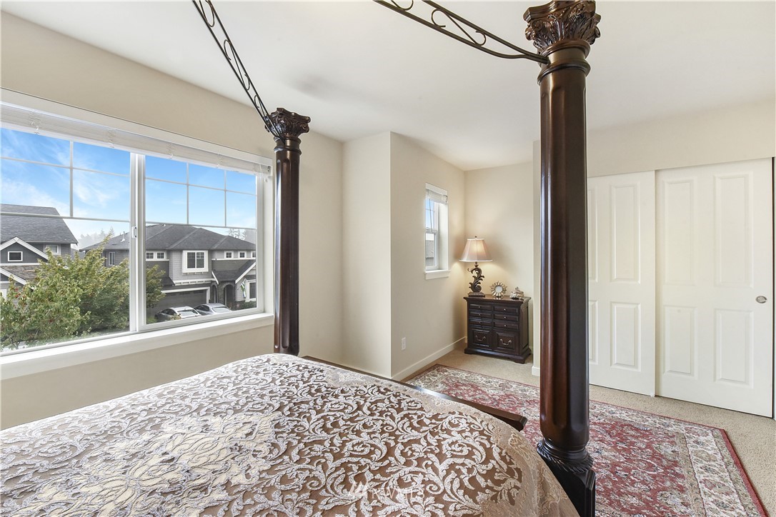 4321 229th Place Southeast Bothell, WA 98021 - Photo 20 of 31 a view of a hallway view with wooden floor and a bedroom