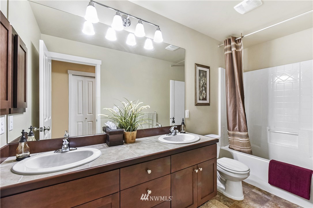4321 229th Place Southeast Bothell, WA 98021 - Photo 21 of 31 a bathroom with a double vanity sink toilet and a mirror