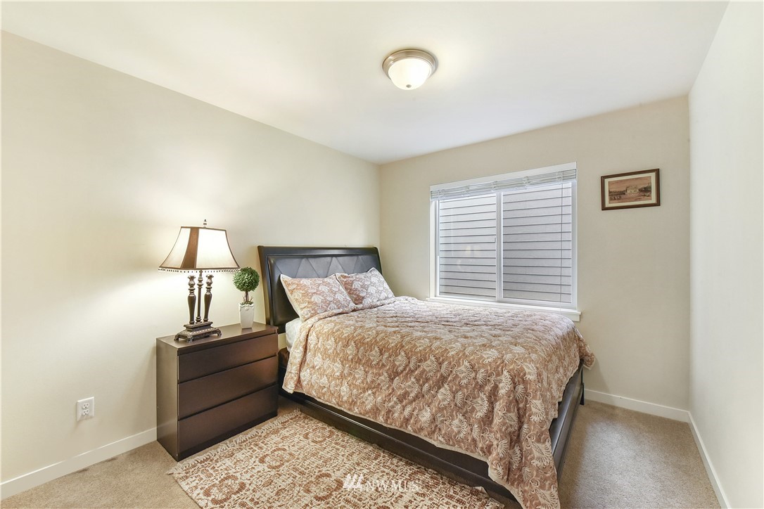 4321 229th Place Southeast Bothell, WA 98021 - Photo 22 of 31 a bedroom with a bed and lamp