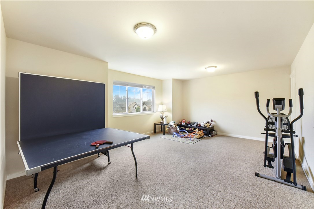 4321 229th Place Southeast Bothell, WA 98021 - Photo 24 of 31 a room with pool table gym equipment mirrors and window
