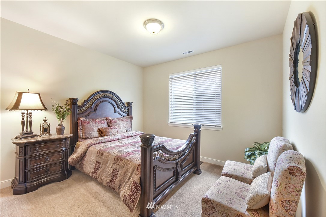 4321 229th Place Southeast Bothell, WA 98021 - Photo 26 of 31 a bedroom with a bed and a dresser