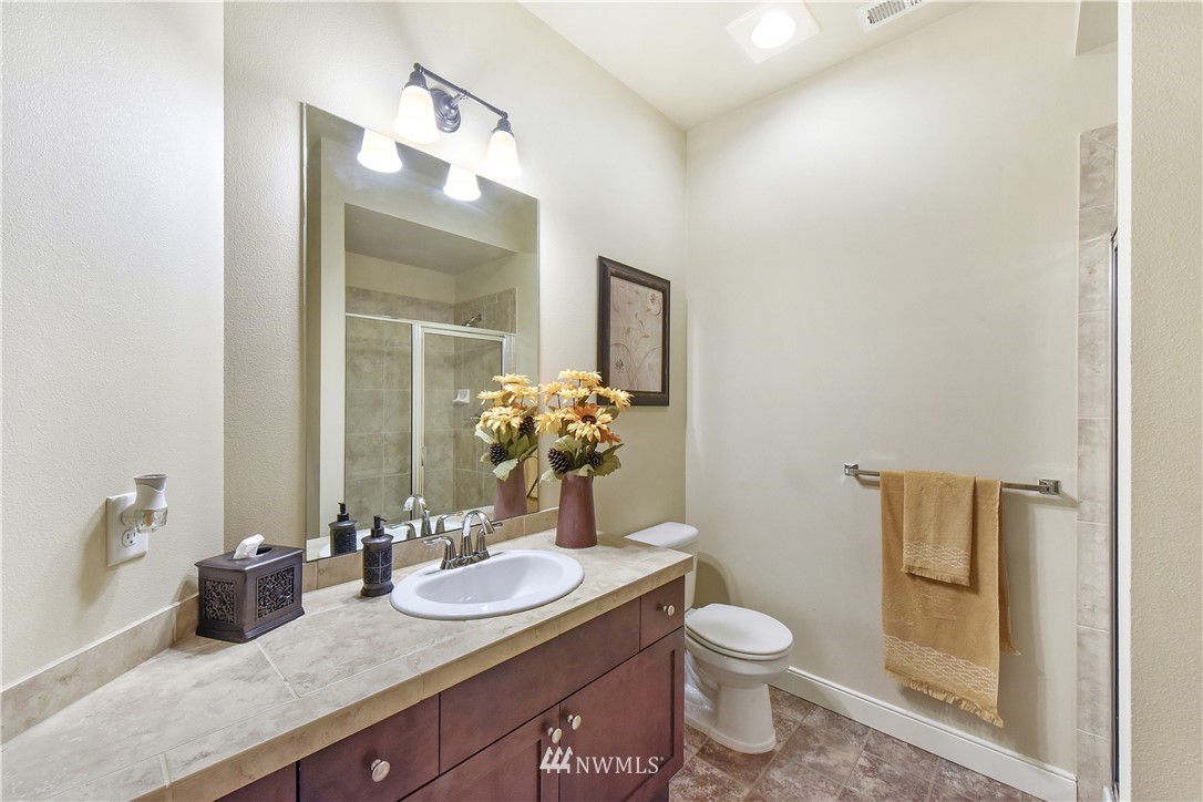 4321 229th Place Southeast Bothell, WA 98021 - Photo 27 of 31 a bathroom with a granite countertop sink toilet and mirror