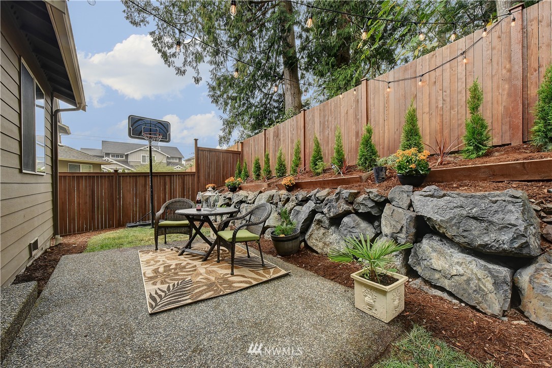 4321 229th Place Southeast Bothell, WA 98021 - Photo 28 of 31 a view of a chairs and table in backyard