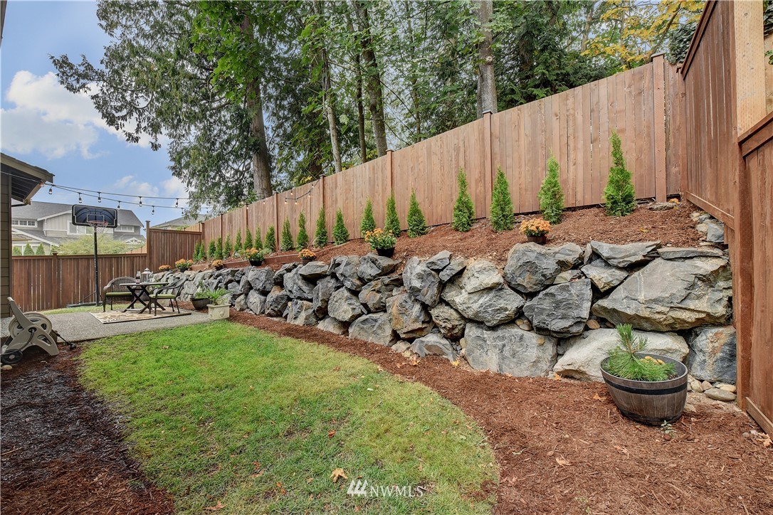 4321 229th Place Southeast Bothell, WA 98021 - Photo 29 of 31 a view of a backyard with plants and wooden fence