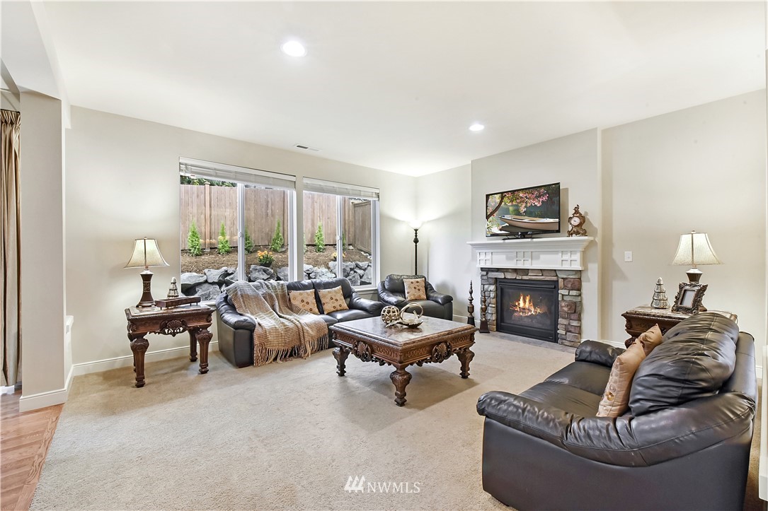 4321 229th Place Southeast Bothell, WA 98021 - Photo 6 of 31 a living room with furniture and a fireplace