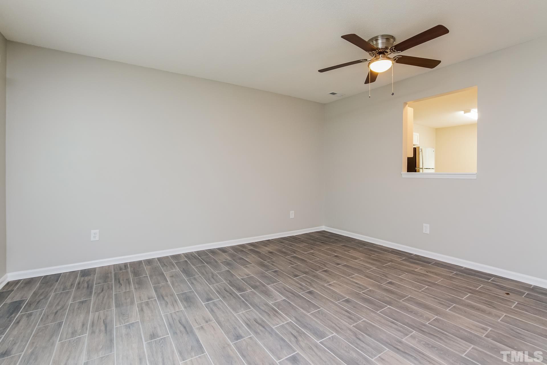 3901 Beaumont Court Raleigh, NC 27604 - Photo 4 of 16 an empty room with wooden floor and windows