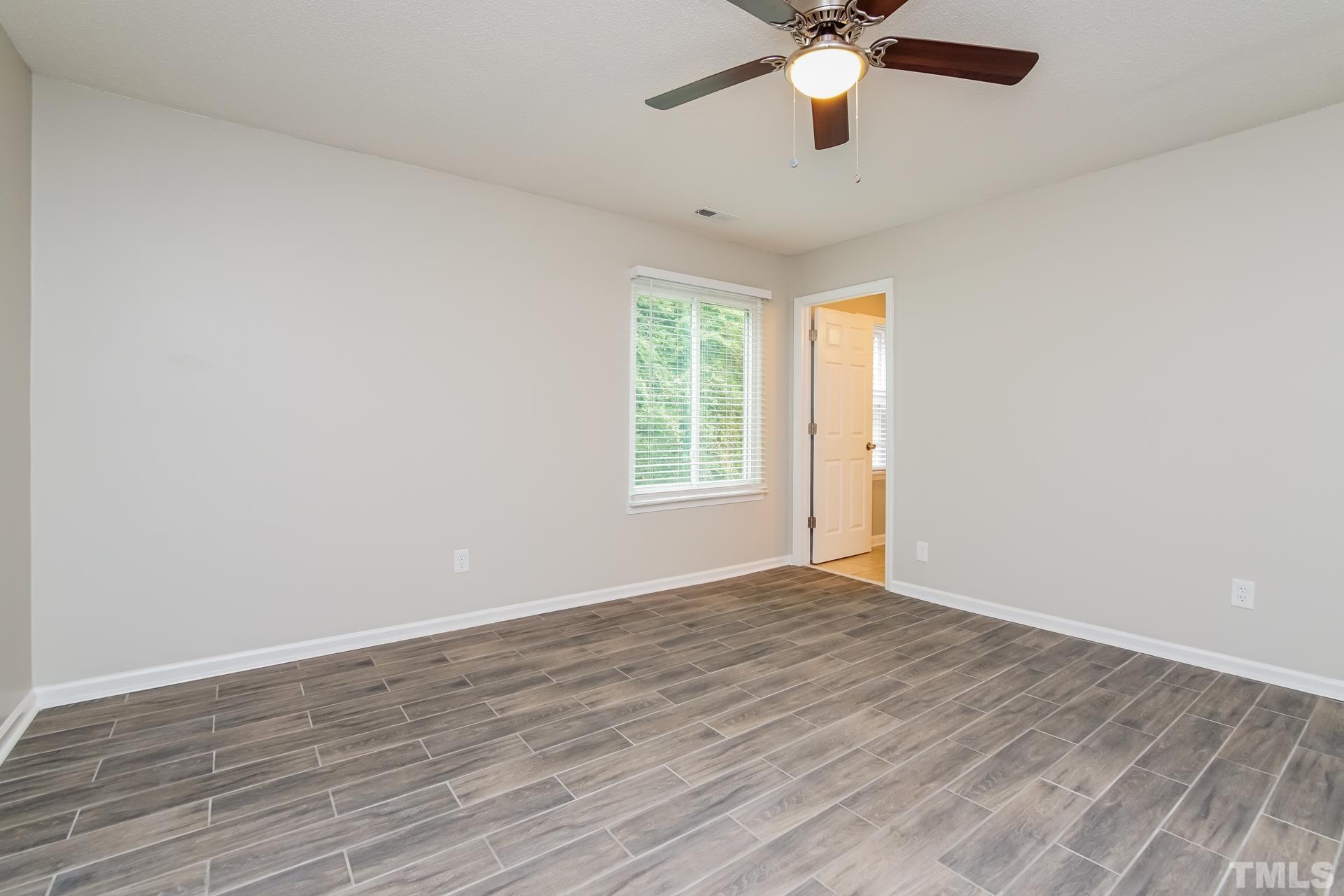 3901 Beaumont Court Raleigh, NC 27604 - Photo 9 of 16 wooden floor in an empty room with a window
