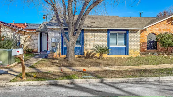 a view of a house with small yard plants and front of main door