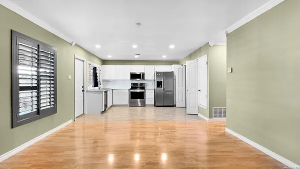 a view of kitchen with stainless steel appliances kitchen island a refrigerator sink and cabinets
