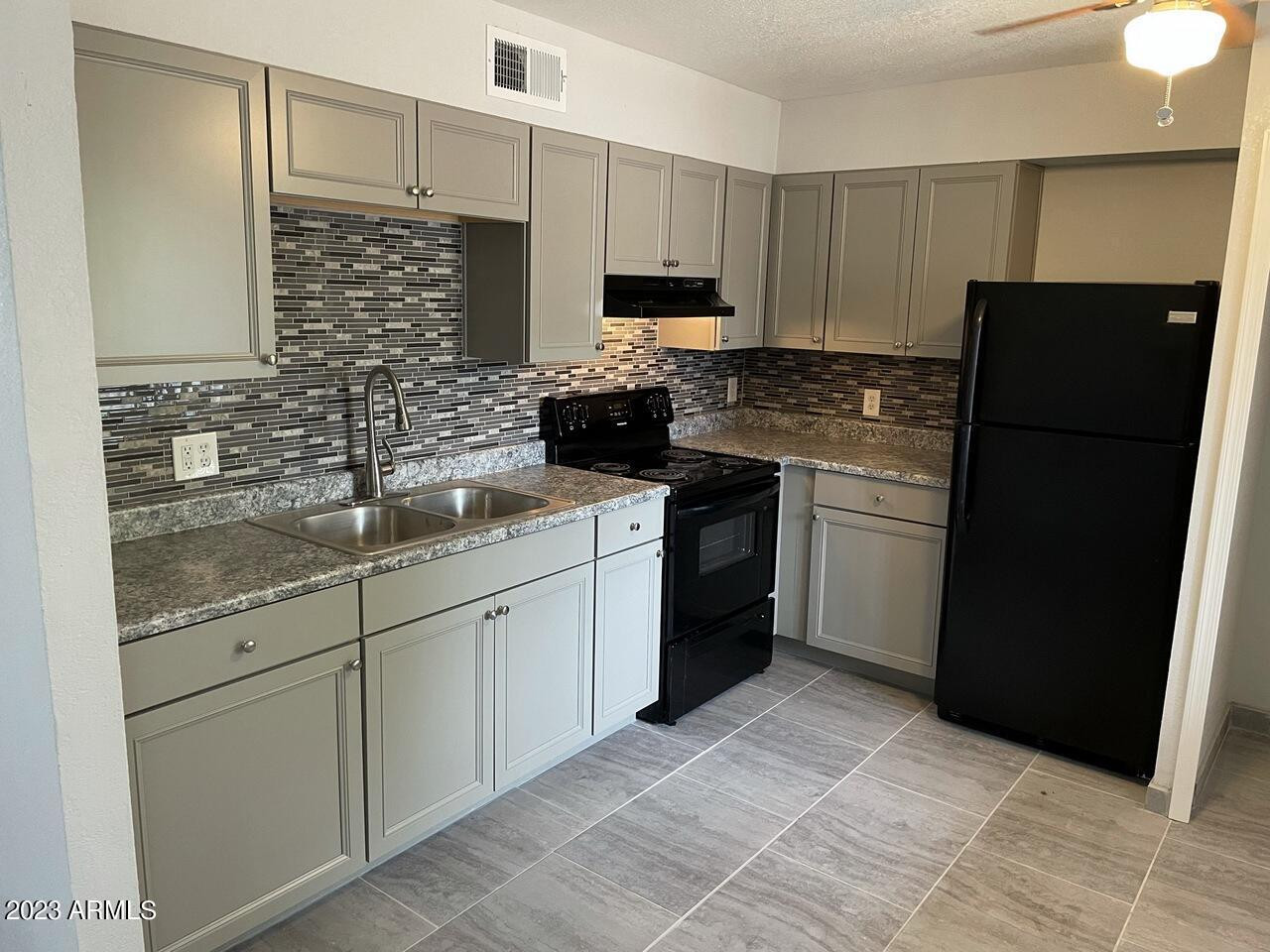 1222 East Mountain View Road, Unit 114 208 214 Phoenix, AZ 85020 - Photo 1 of 21 a kitchen with stainless steel appliances granite countertop a refrigerator stove and sink