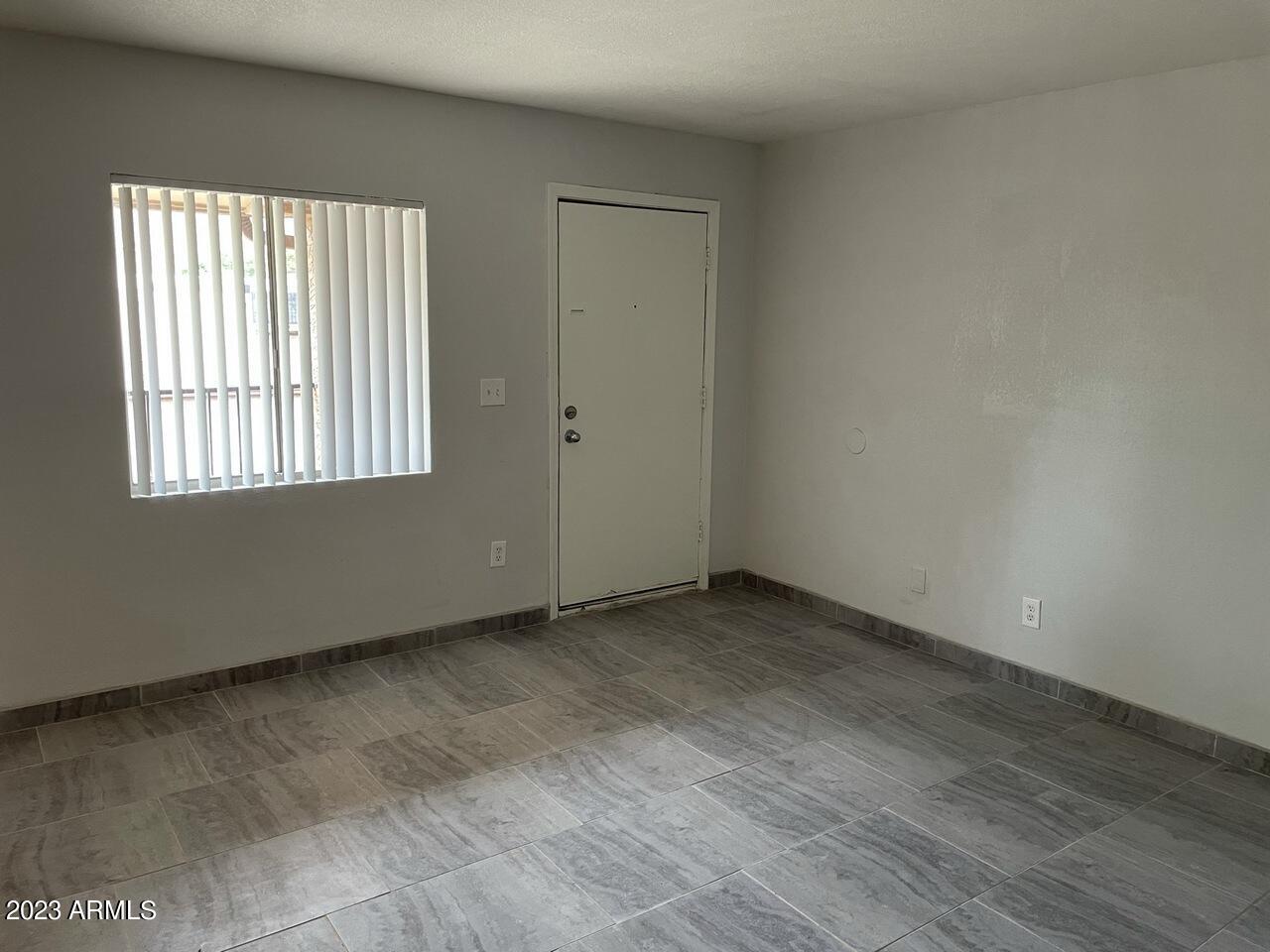 1222 East Mountain View Road, Unit 112 114 Phoenix, AZ 85020 - Photo 11 of 21 an empty room with wooden floor and windows